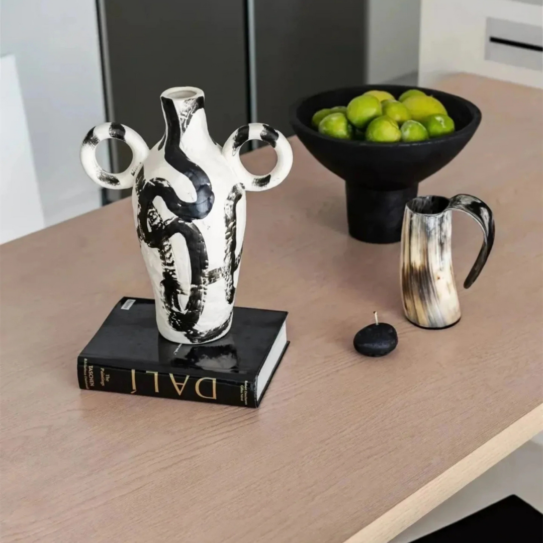 Unique ceramic vase featuring intricate black paint design - a statement piece for organic modern interiors