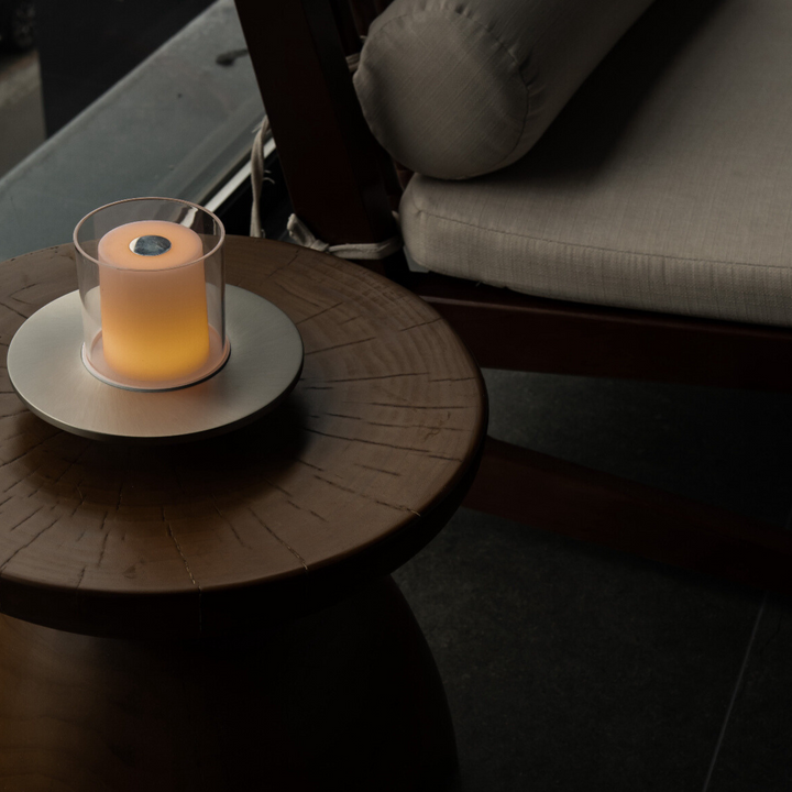 Adjustable lighting modes candle lamp placed on a modern wooden table for cozy ambiance.