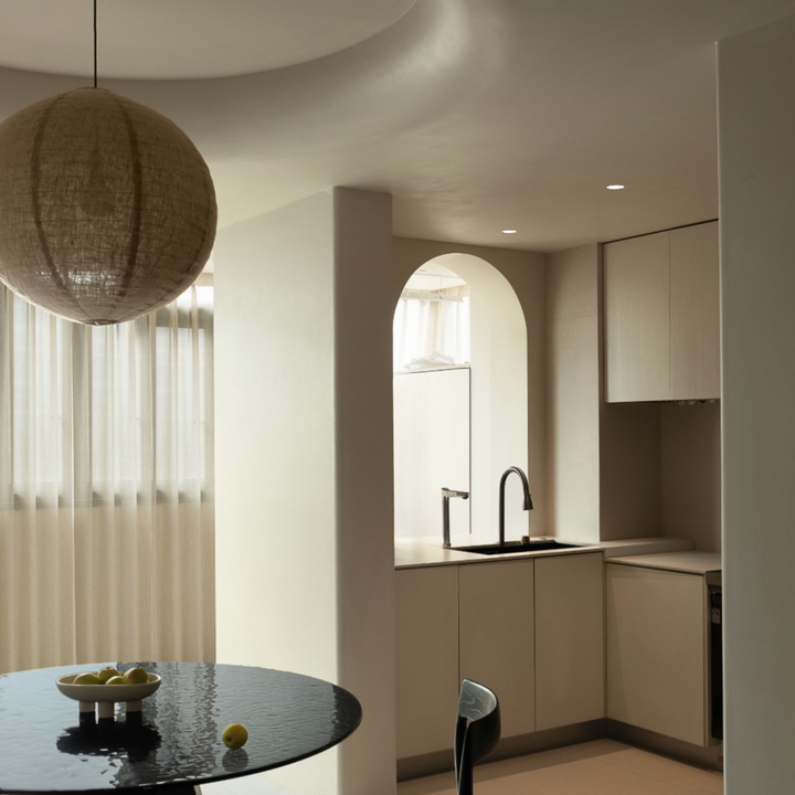 Aesthetic fabric pendant light with subtle shadows in a neutral interior.