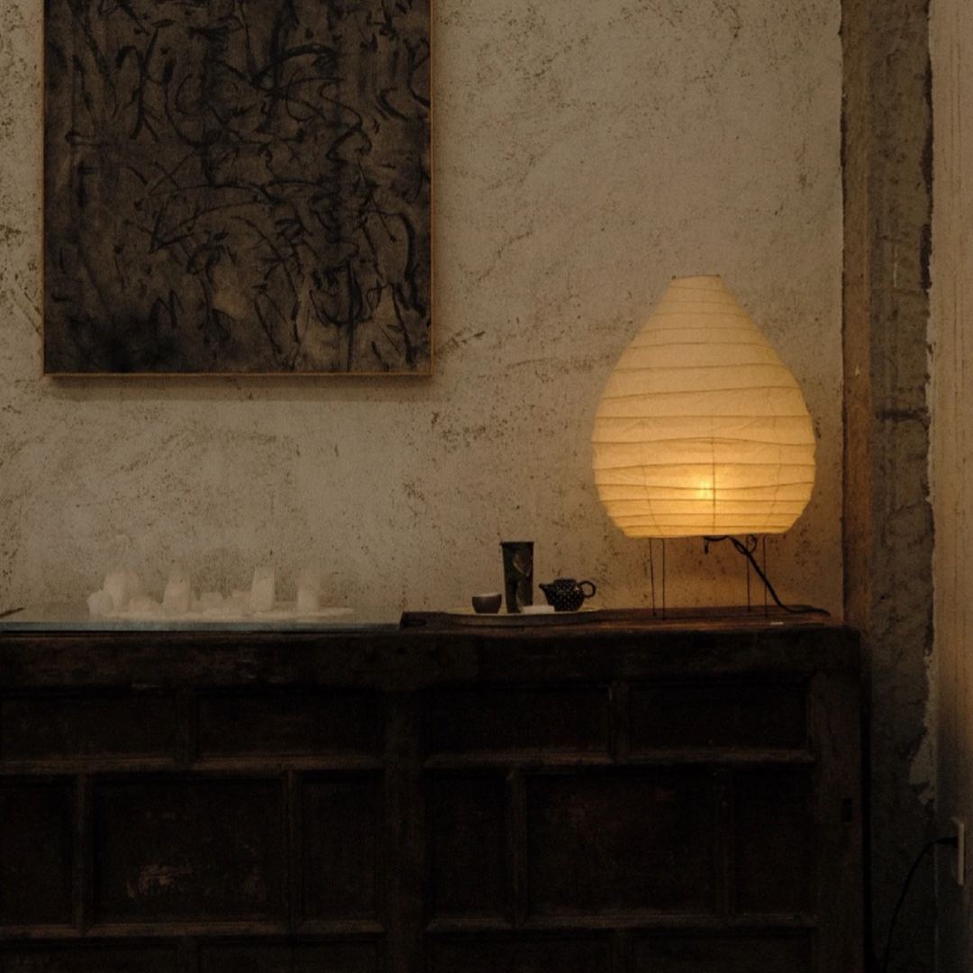 Aesthetic floor lighting in a dark-toned modern apartment corner styled with neutral elements.