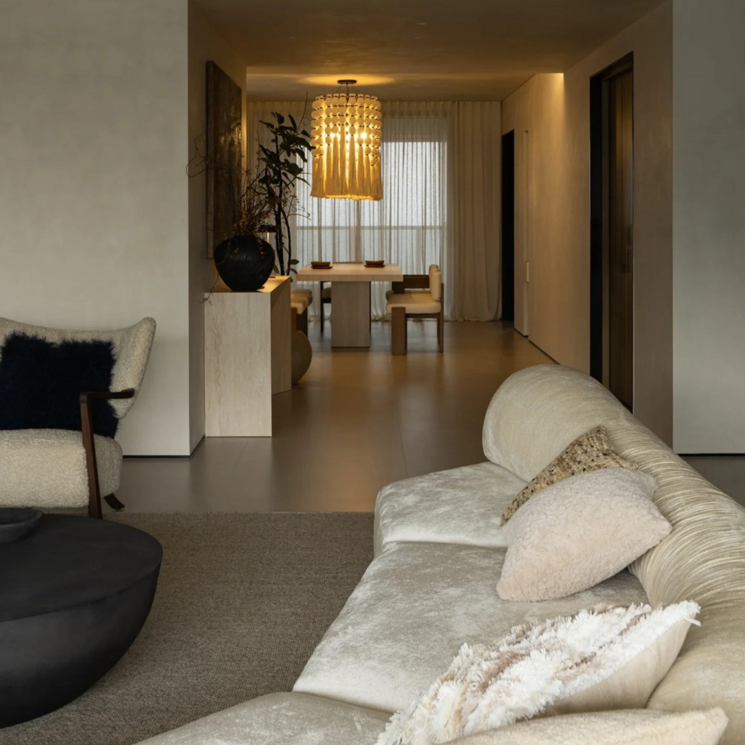 Aesthetic neutral-tone lighting hanging above modern living and dining area.