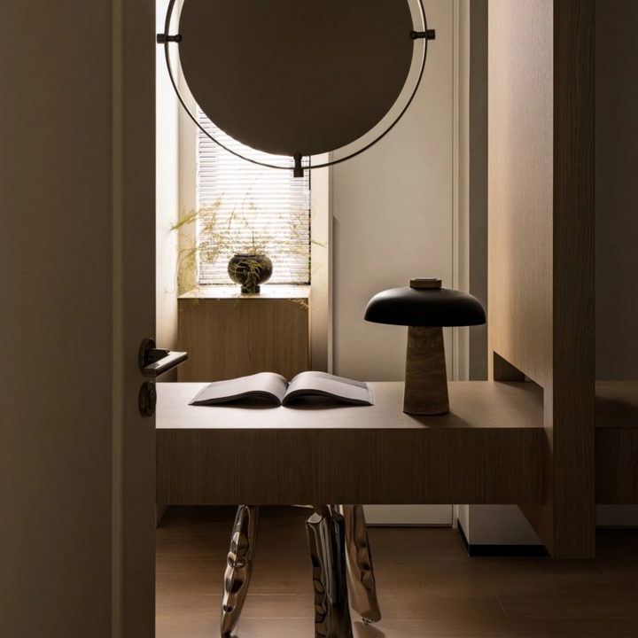 Table lamp providing ambient light in a serene home office environment.