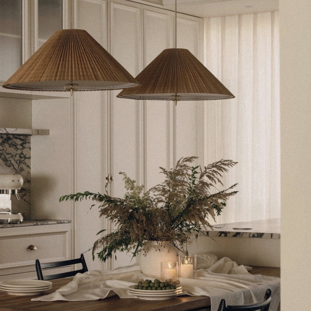 bamboo ceiling pendant light suspended above a dining table creating warm natural lighting in a kitchen dining space.