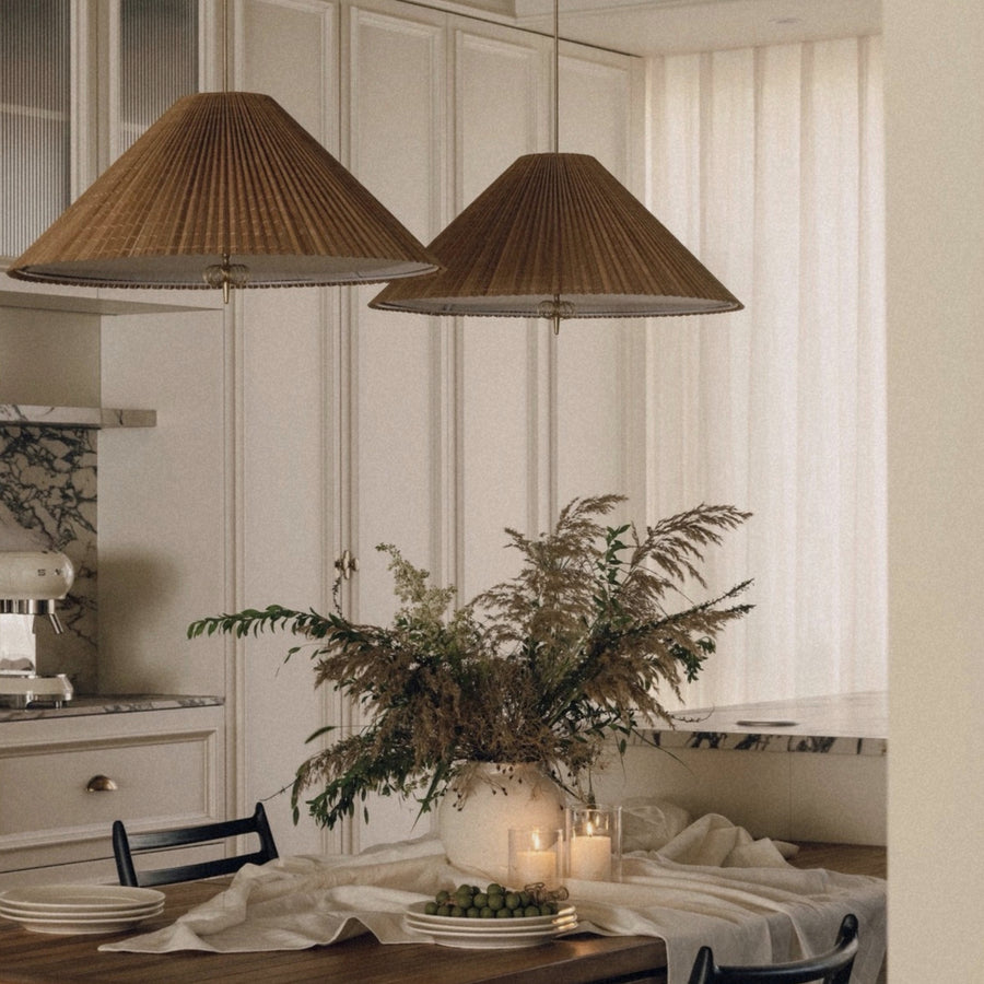 bamboo ceiling pendant light suspended above a dining table creating warm natural lighting in a kitchen dining space.