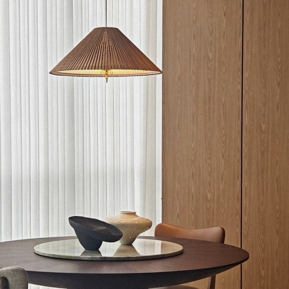 bamboo pendant lamp hanging above a round dining table in a calm contemporary interior.