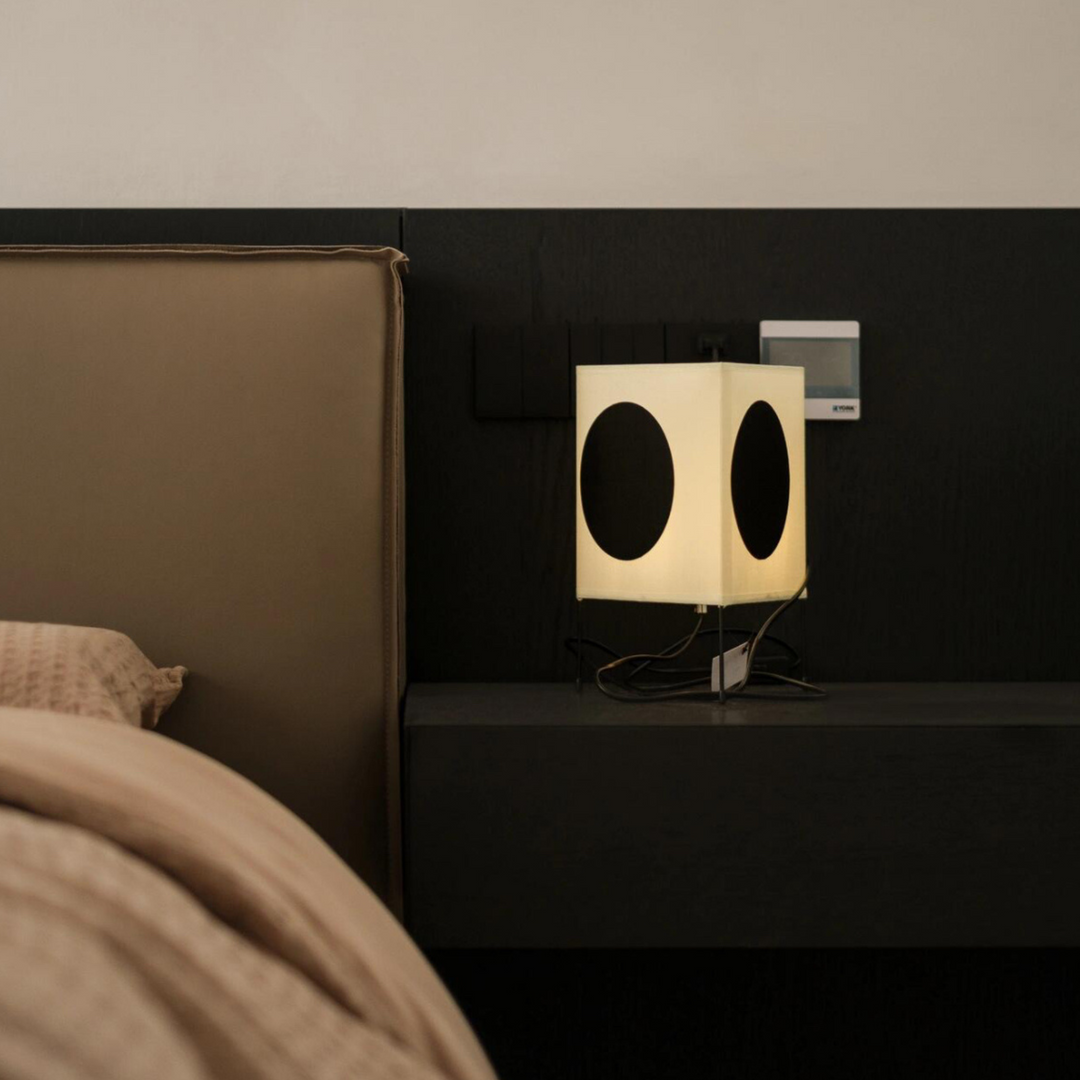 Modern lamp on a bedroom nightstand, offering a simplistic yet elegant lighting solution.