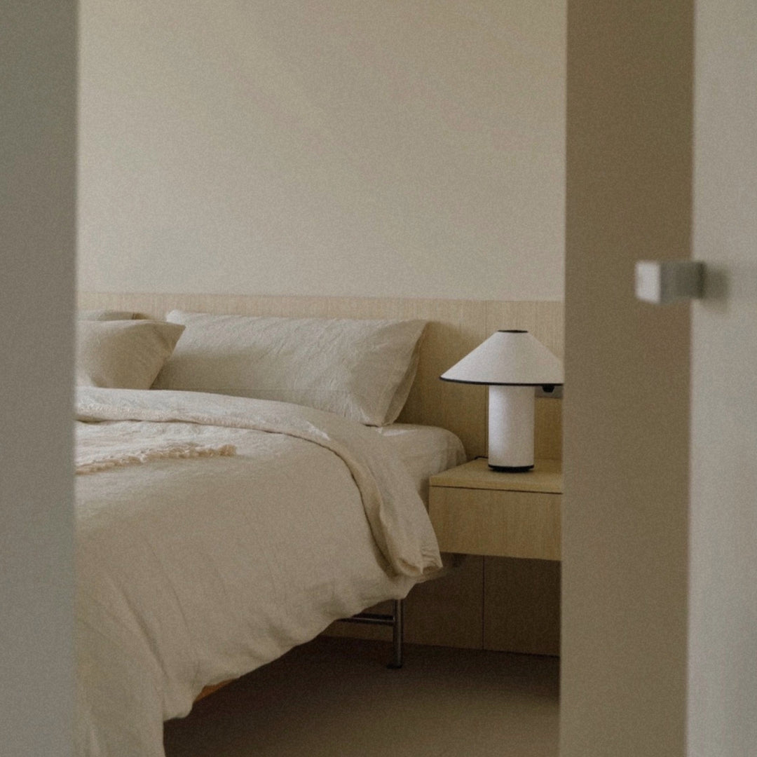 bedside lamp set in a clean bedroom corner with soft neutral tones.