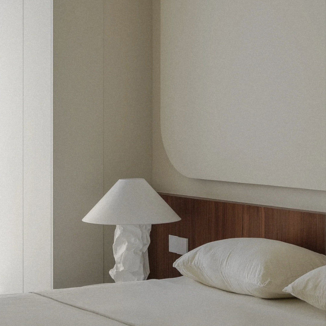 bedside lamp adding gentle light to a minimal bedroom setup.
