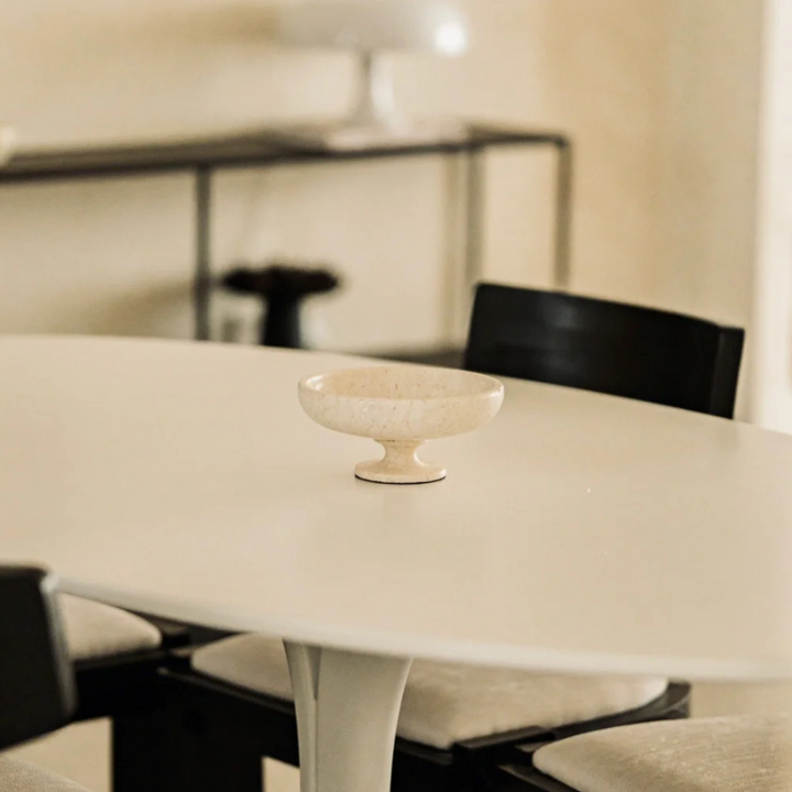 Travertine centerpiece bowl adding elegance to a modern interior.