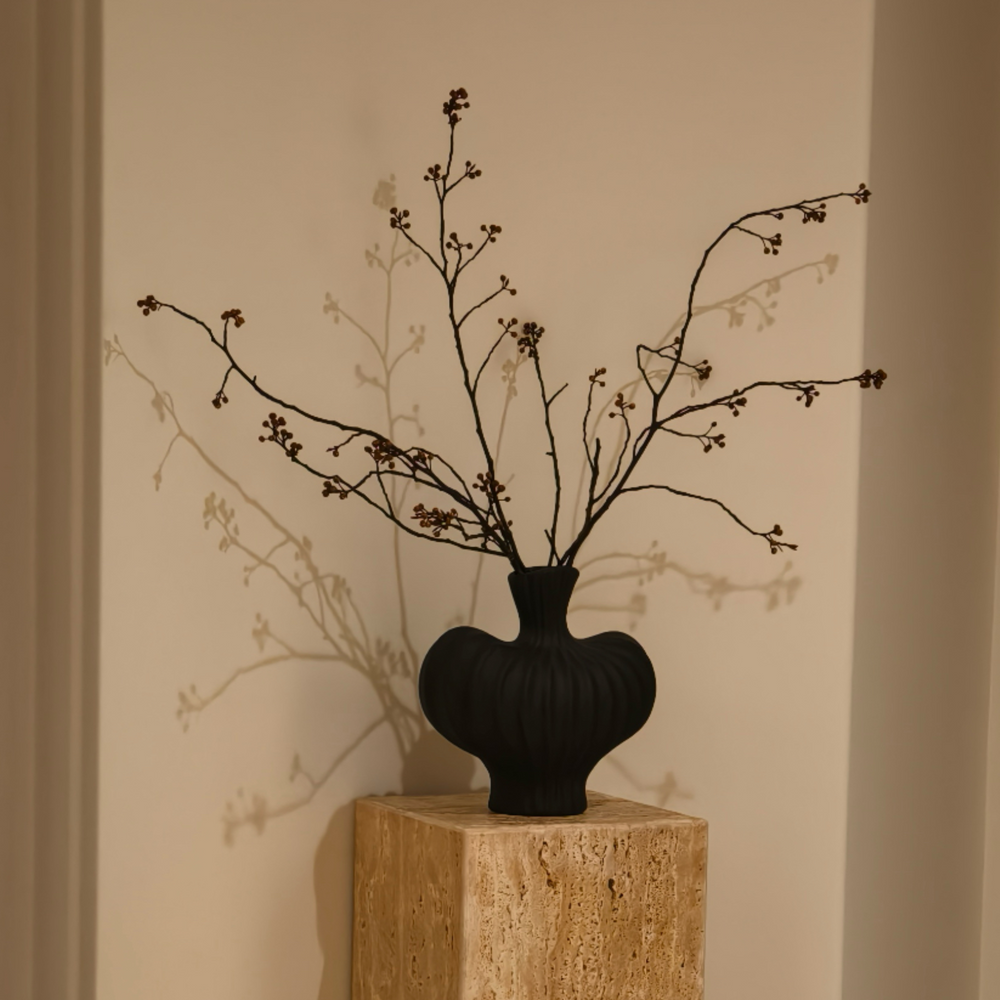 Black ceramic vase with organic wavy texture, perfect for modern minimalist decor.