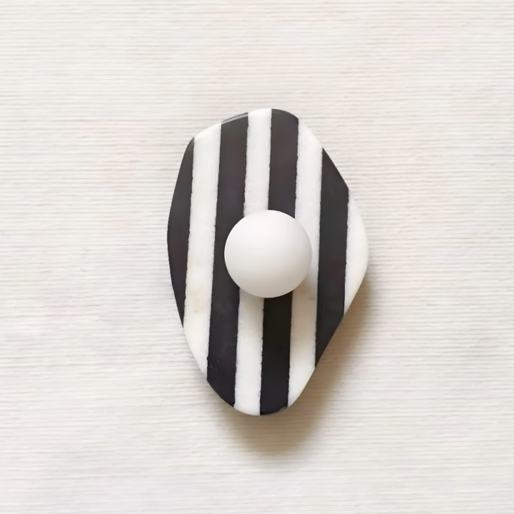 Black and white striped marble wall lamp featuring a sleek round light, perfect for adding a touch of elegance to contemporary and minimalist interiors.