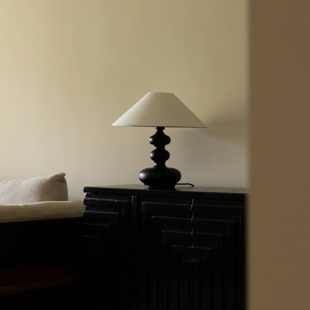 Black wooden table lamp featuring a retro wavy design, ideal for mid-century modern interiors.