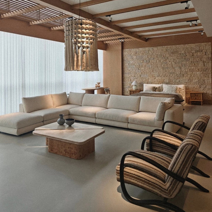 boho cotton pendant light suspended above a living room seating area adding soft ambient light.