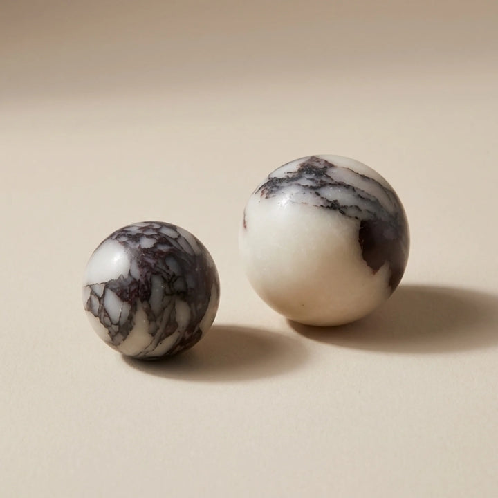 set of spherical bulgari stone knobs on a soft neutral backdrop.