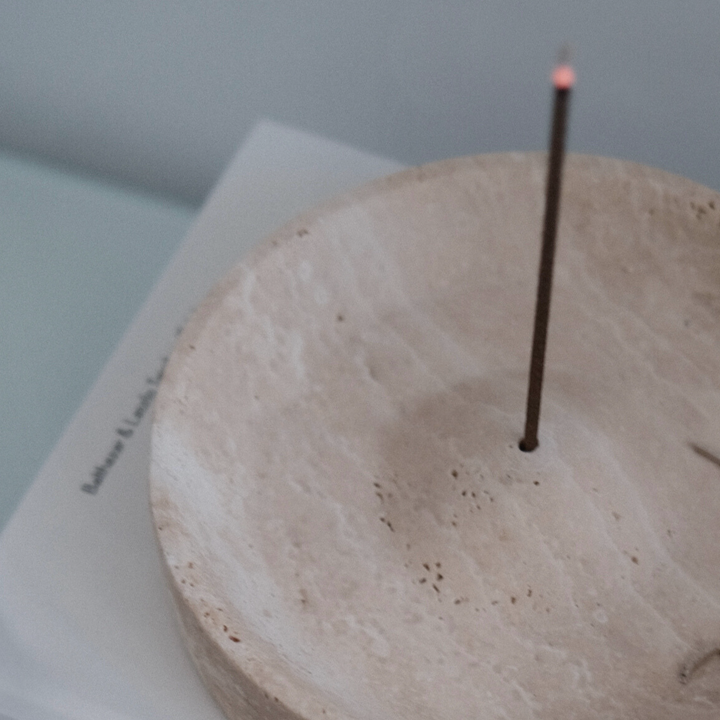 Close-up of a travertine incense holder with natural patterns, ideal for calm spaces.