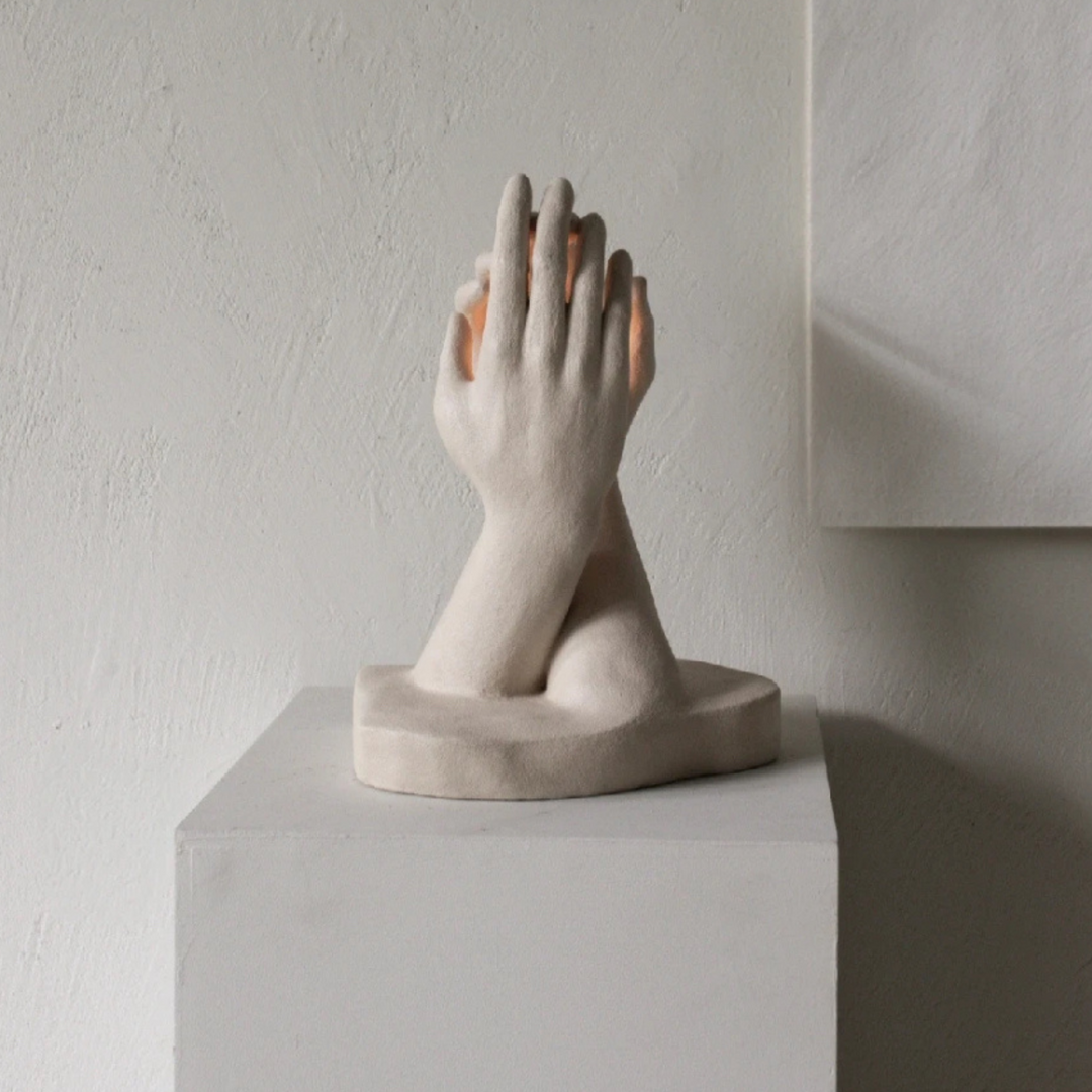 Minimalist candle holder with flame, styled on pedestal