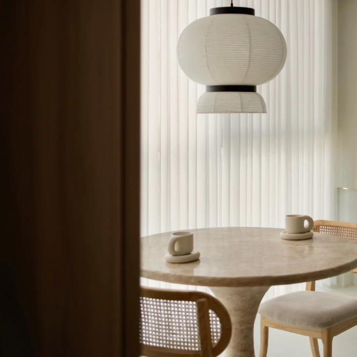 Chunky ceramic mug and plate set on a dining table with a minimalist aesthetic.