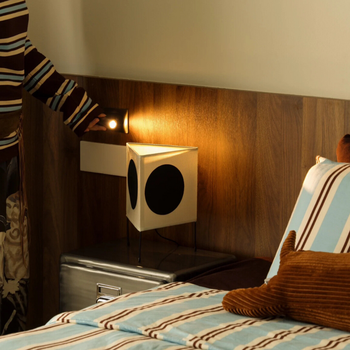 Chic lamp adding a contemporary touch to a stylish bedroom setup.