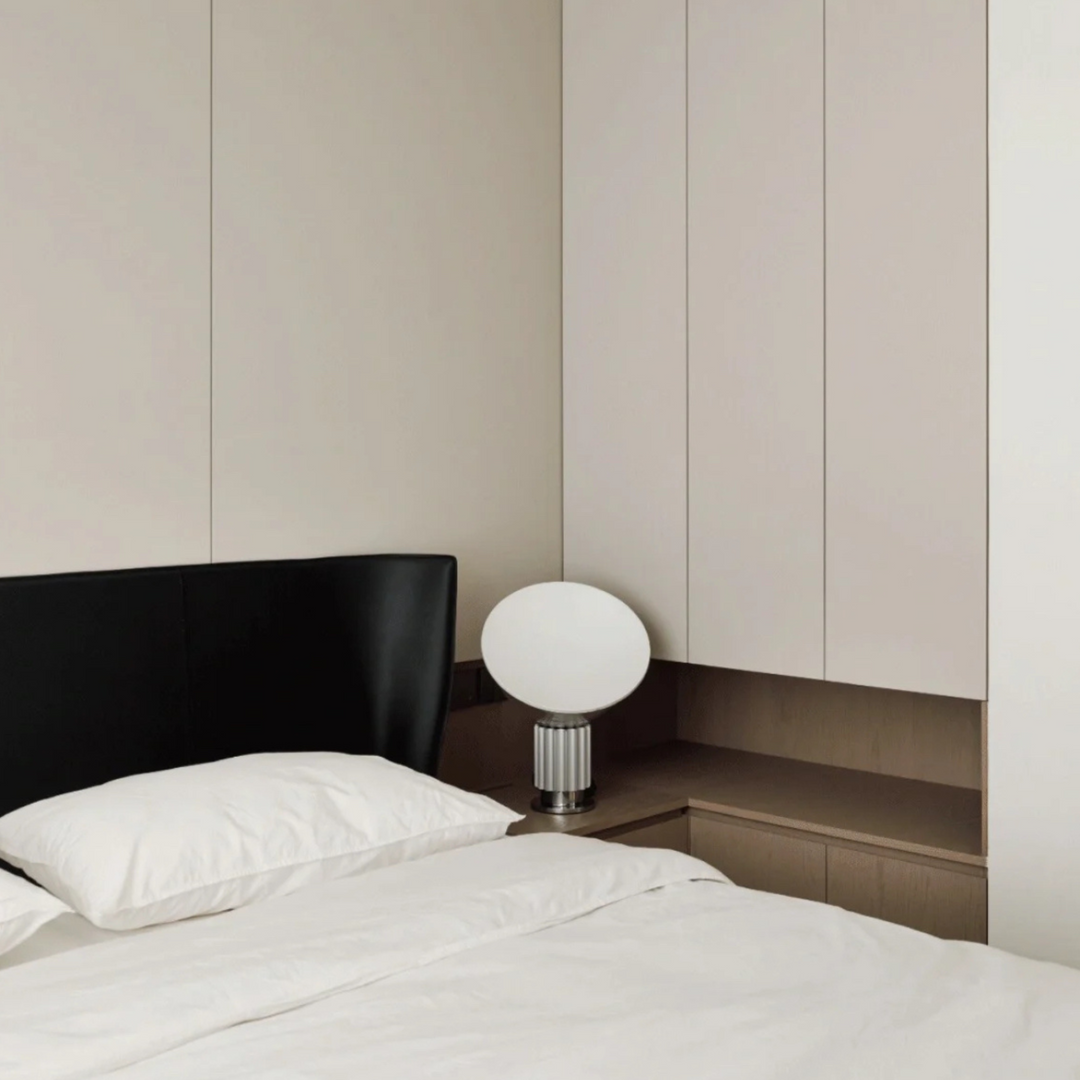 Classic bedroom with dark headboard and modern lamp