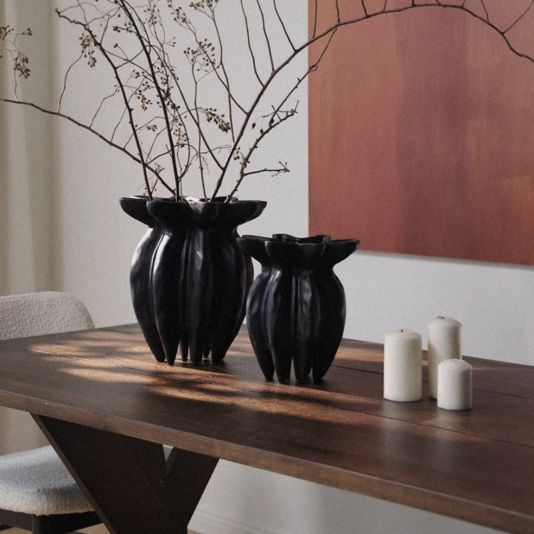 contemporary ceramic vase positioned on a dining table creating a simple decorative focus.