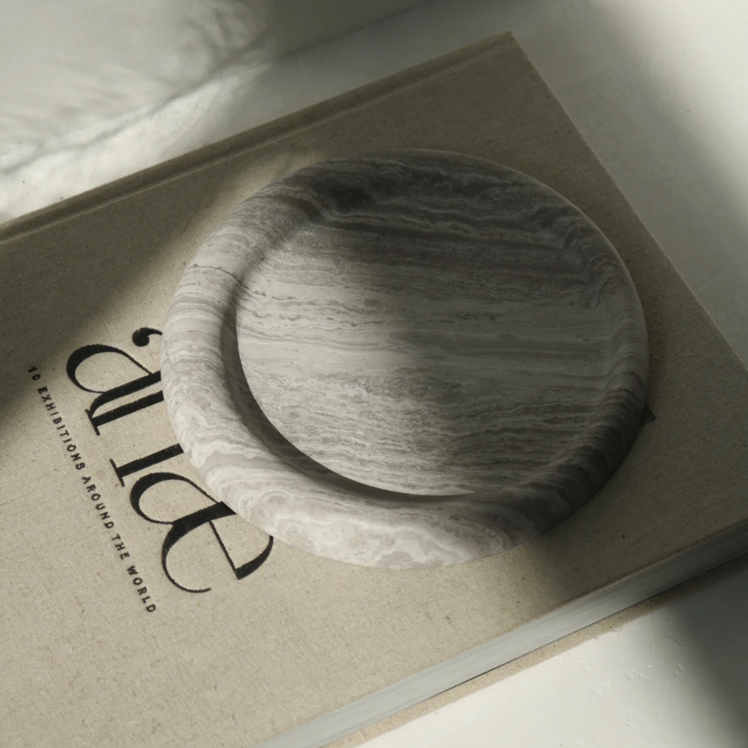 Contemporary marble tray design with refined edges, a chic addition to any table setting.