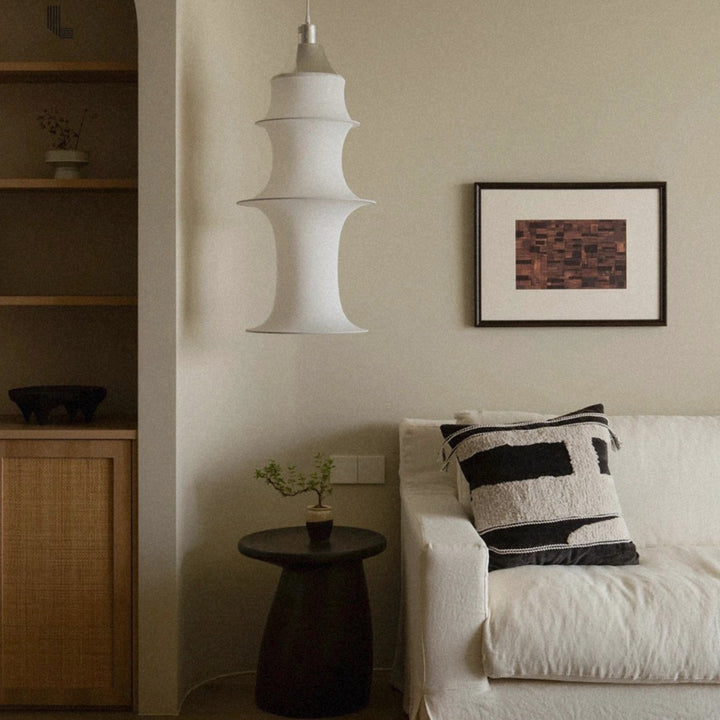contemporary pendant light suspended in a lounge area creating warm ambient lighting.