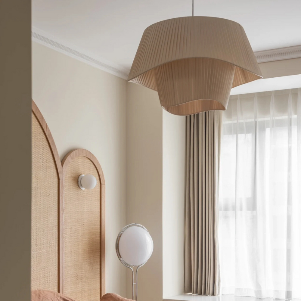 Contemporary pendant light with pleated detailing, perfect for a modern bedroom.