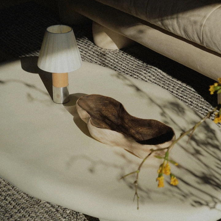 cordless table lamp used on a coffee table with decorative objects.