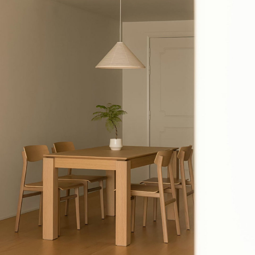 Handcrafted cotton paper lamp casting warm light in a serene minimalist interior.