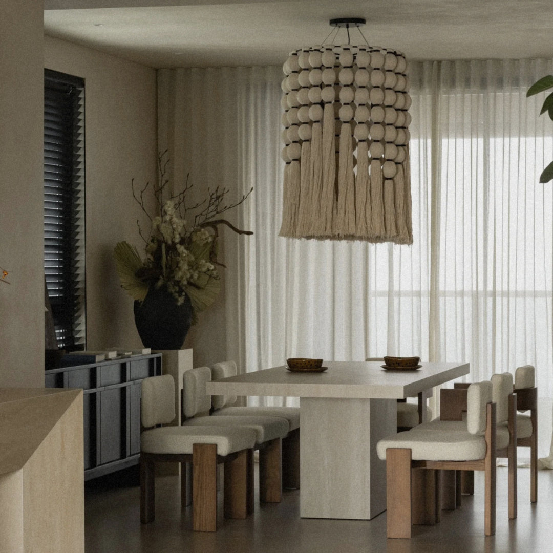 cotton thread fringe pendant light hanging above a dining table in a calm modern interior.