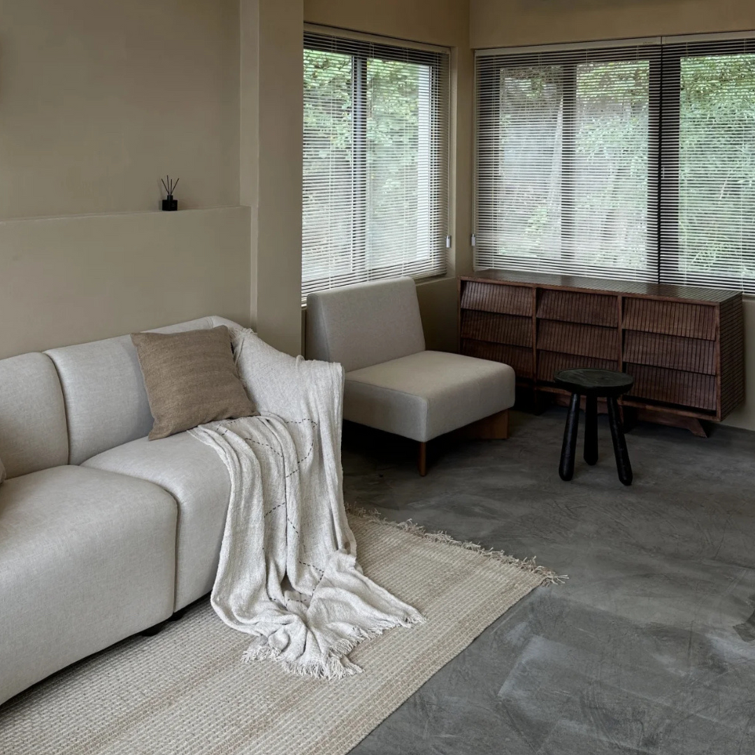 Cozy living room featuring a vintage-style side table with natural wood imperfections.