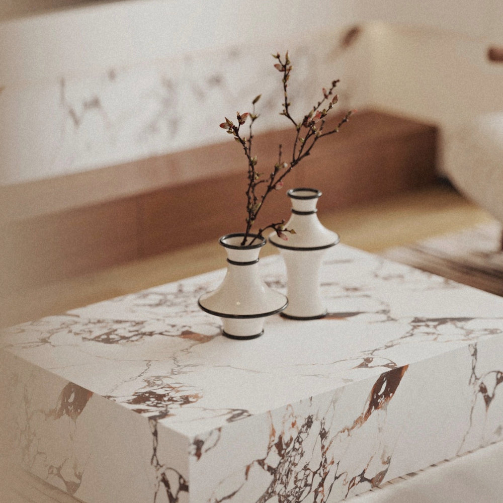 decorative ceramic vases arranged on a marble coffee table creating a refined minimalist home decor composition.