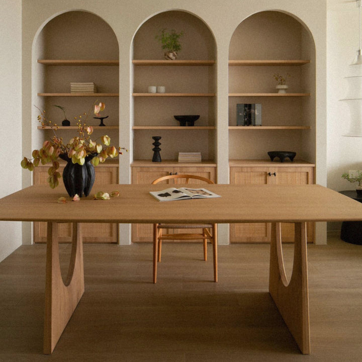 decorative ceramic vase displayed on a wooden table in a calm dining room setting.