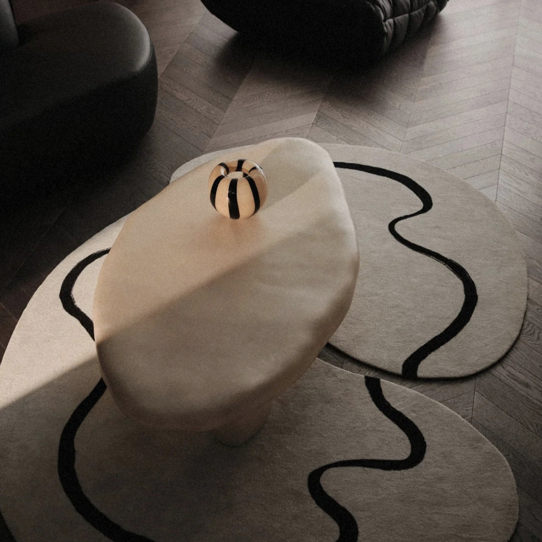 decorative glass vase used as a subtle accent on a minimalist coffee table.