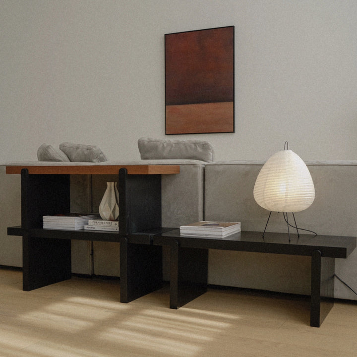 decorative paper table lamp styled on a long console table in a calm contemporary living space.