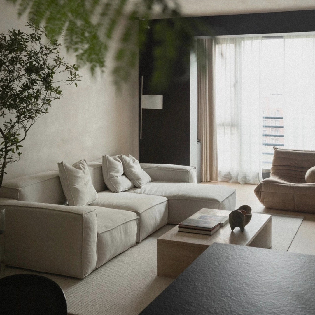 decorative wooden bowl styled on a living room coffee table with books and soft neutral seating.