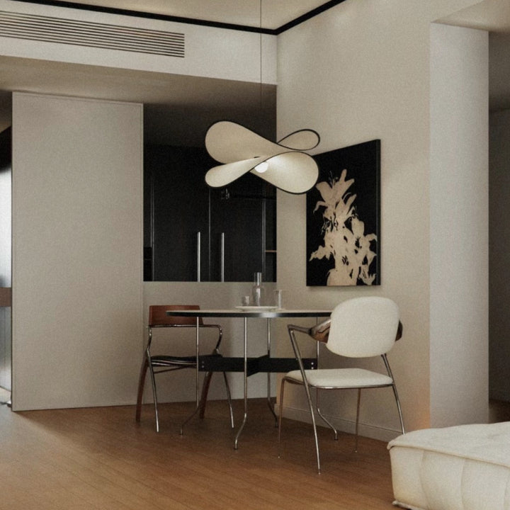 designer pendant light hanging over a dining area in a contemporary interior.