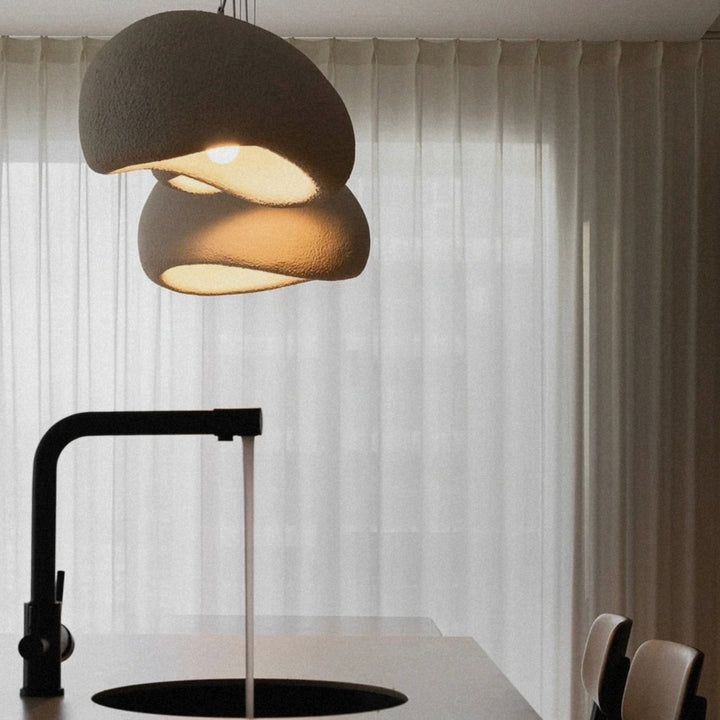 designer pendant light placed above a sink area in a clean kitchen space.