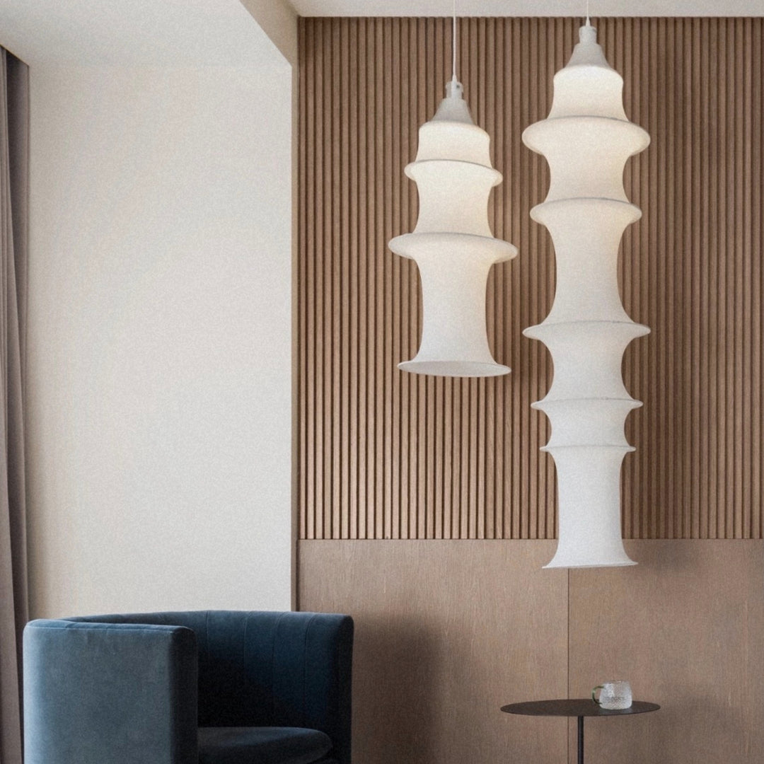 designer pendant light suspended in a contemporary interior adding a sculptural lighting element.