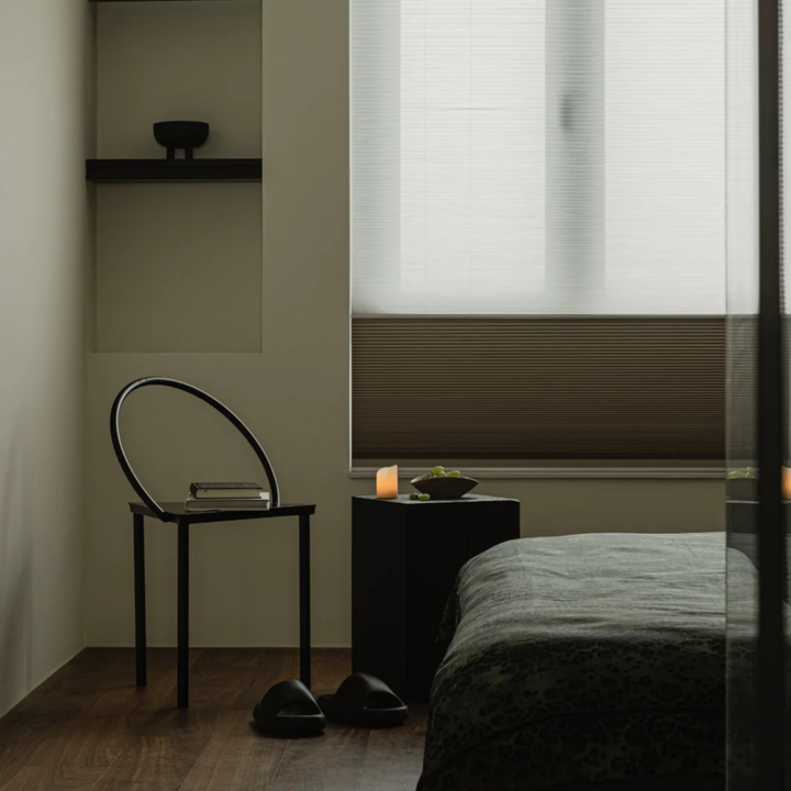 Geometric steel chair adding industrial charm to a minimalist bedroom.