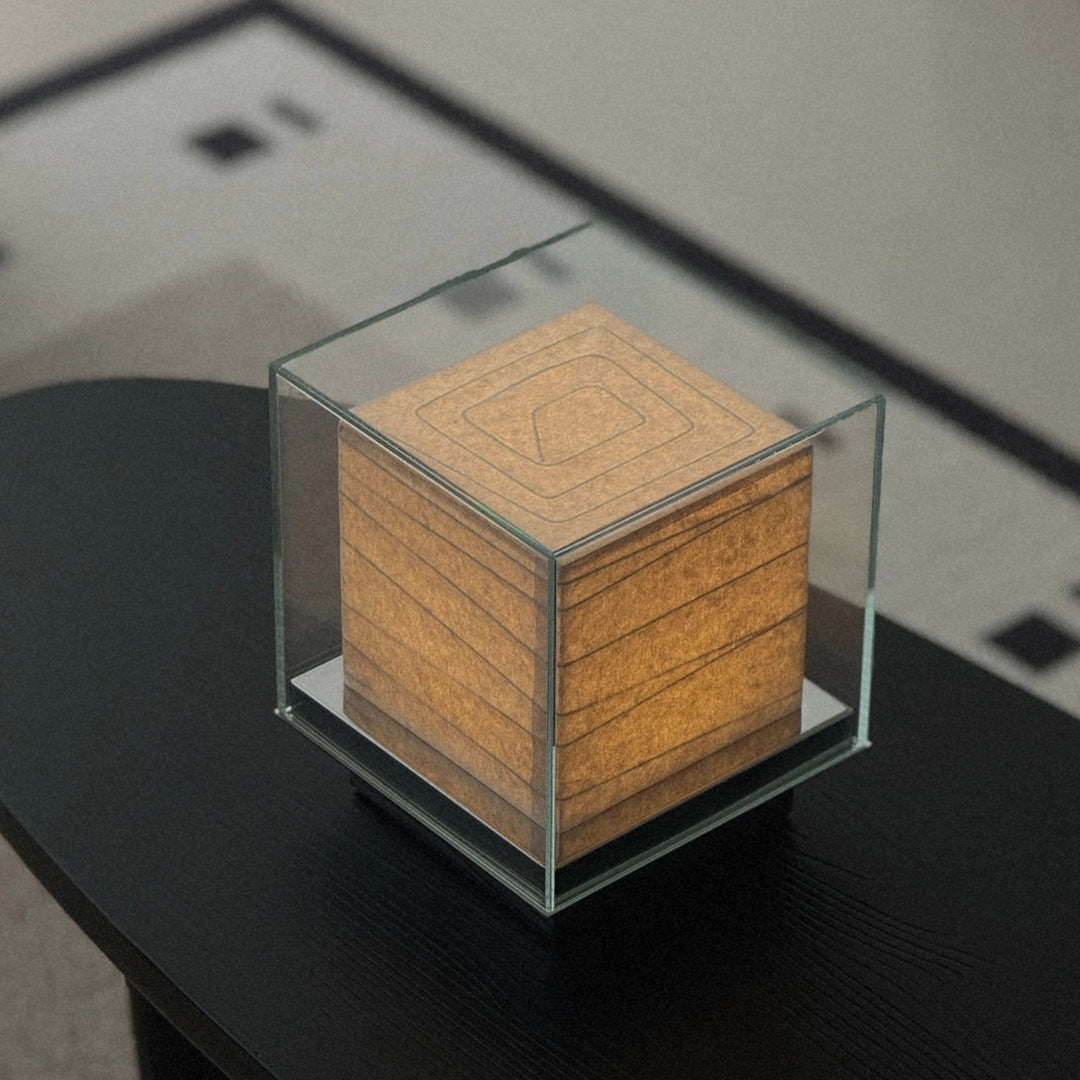 glass cube table lamp used as a soft lighting element in a modern space.