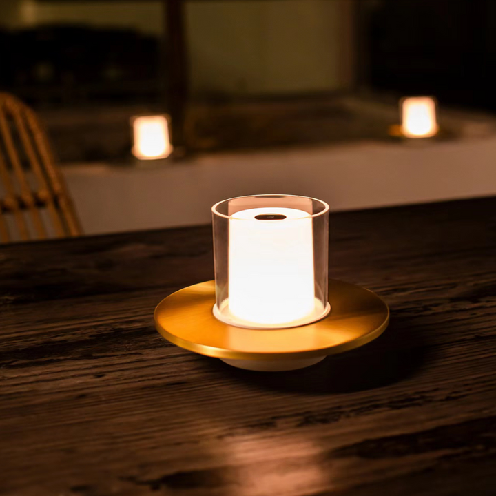 Gold candlelight lamp with minimalist design, providing ambient lighting for indoor spaces.