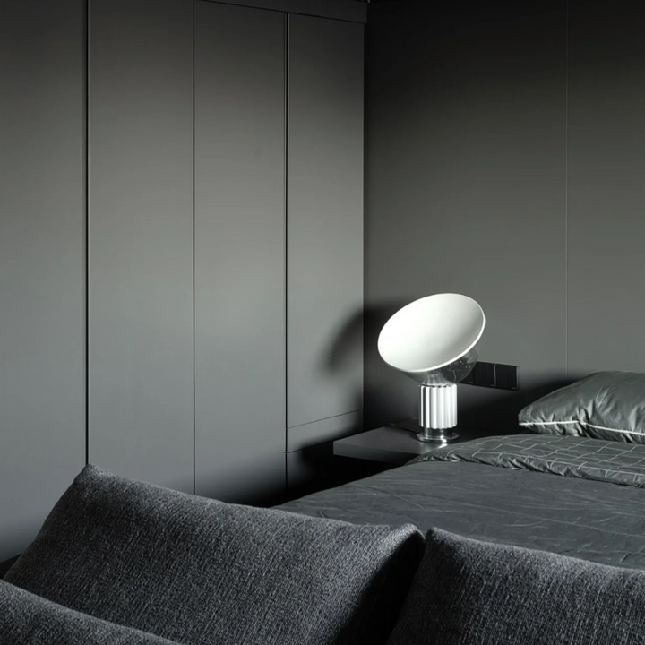 Monochromatic gray bedroom featuring a sleek modern lamp, urban style