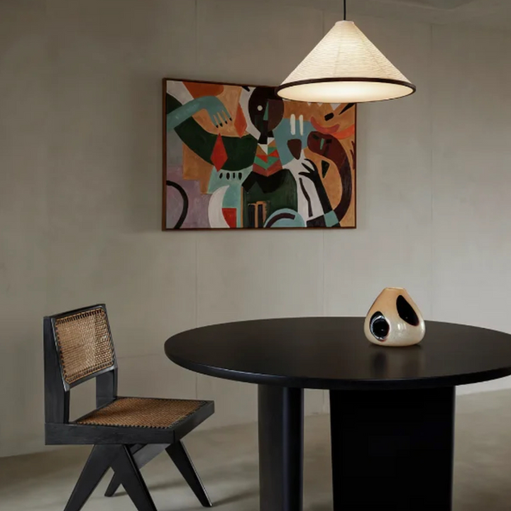 A neutral-toned dining room featuring a cotton paper pendant lamp with soft, diffused light.