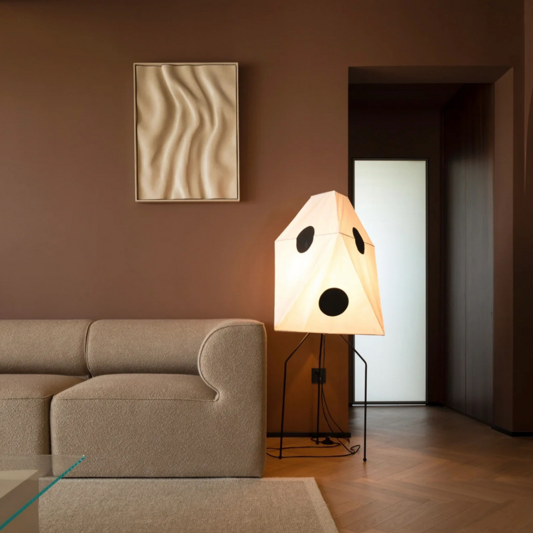 With bold geometric details, this cotton paper floor lamp brings artistic charm to a warm brown living room.