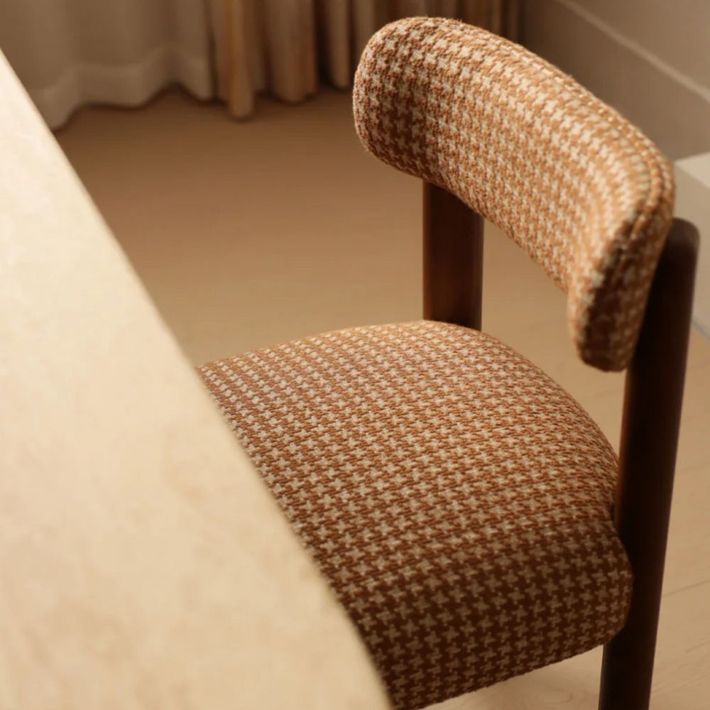 Chair upholstered in a stylish houndstooth fabric with an Oak wooden frame, ideal for mid-century and modern decor.