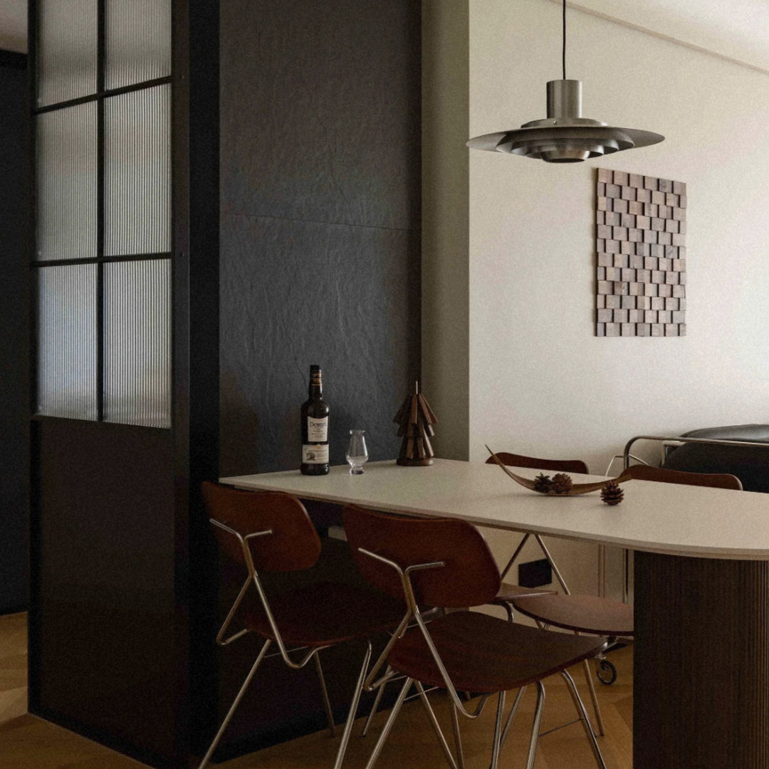 industrial pendant light positioned above a kitchen bar with seating.