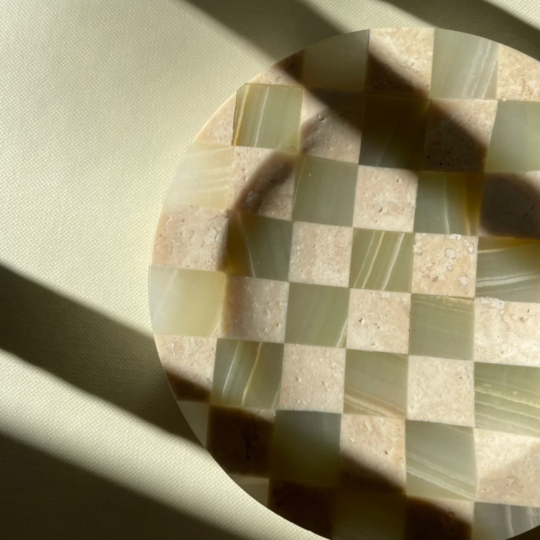 Unique checkerboard tray featuring jade marble and travertine textures, complementing the natural decor.