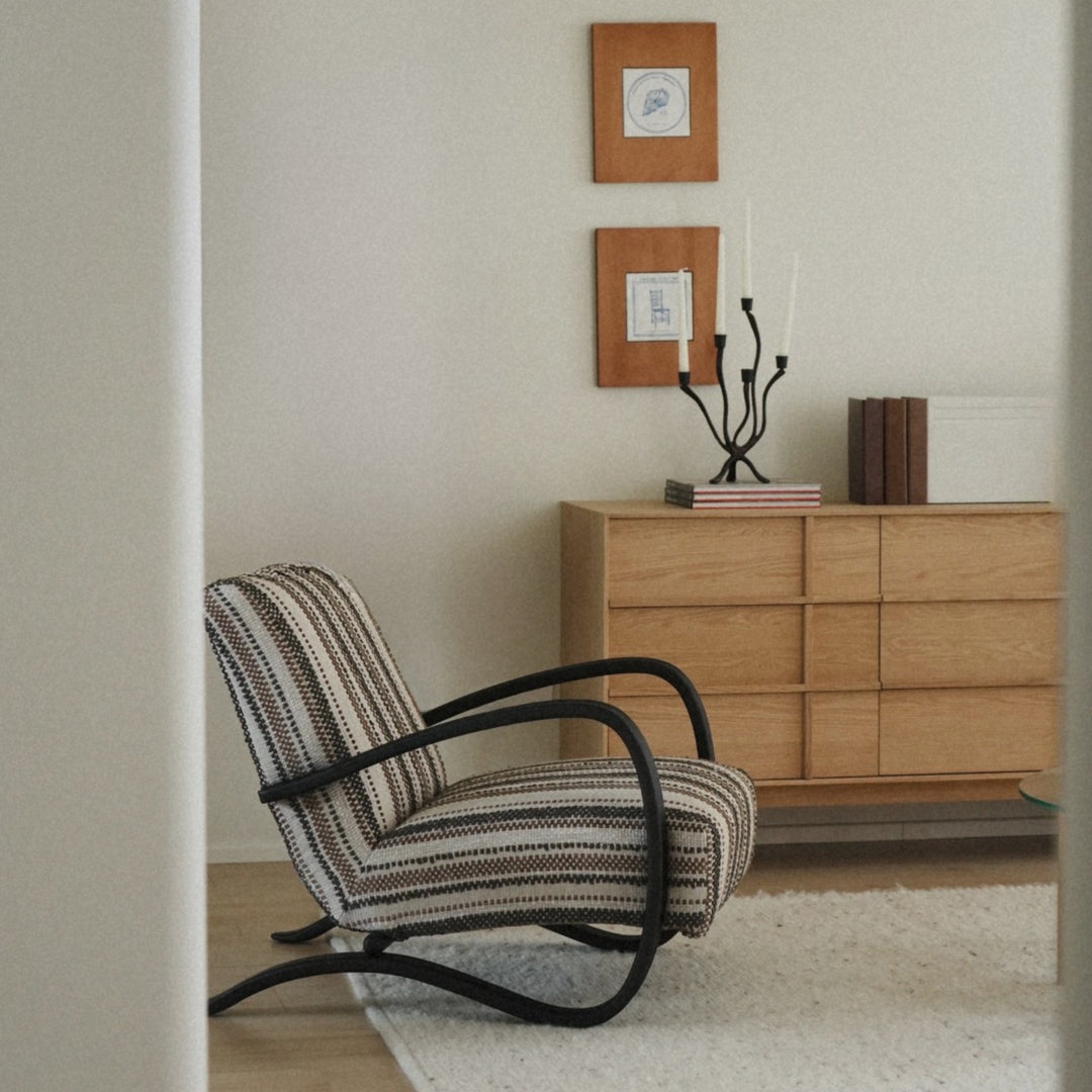 softly curved candle holder styled in a japandi interior with calm tones