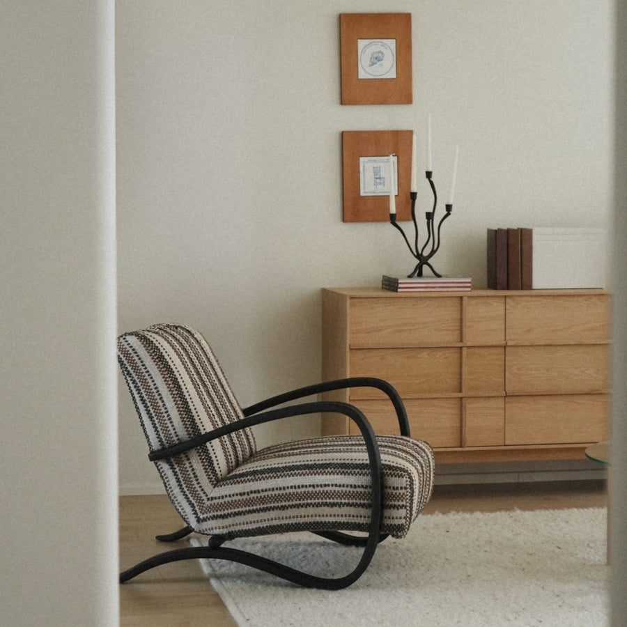 softly curved candle holder styled in a japandi interior with calm tones